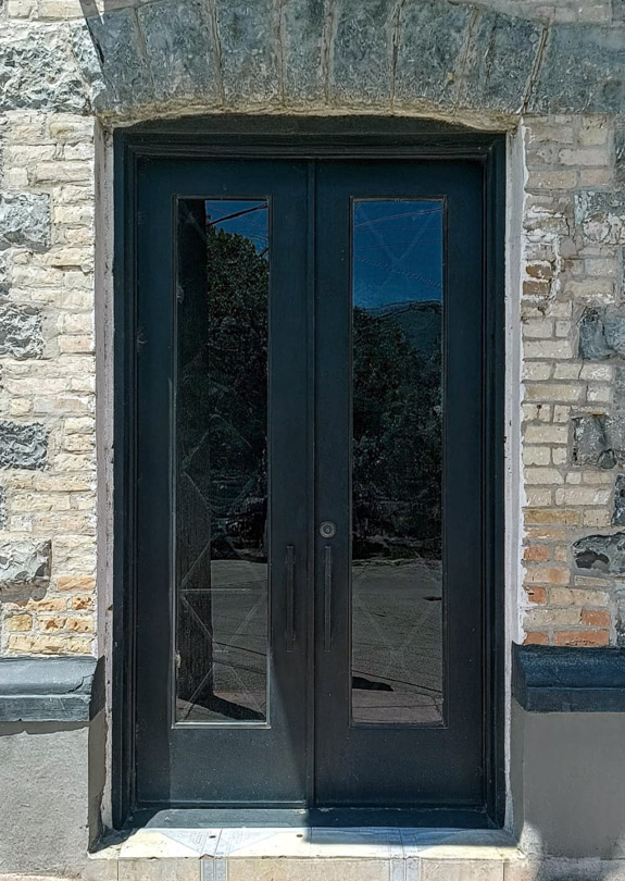 Modern steel door with tall glass panel wood finish Texas